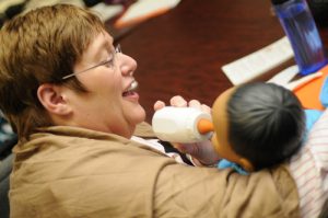 Teacher feeding RealCare Baby