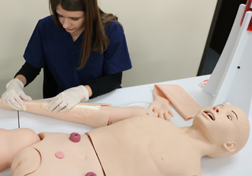 Student using Realityworks' Nursing Manikin