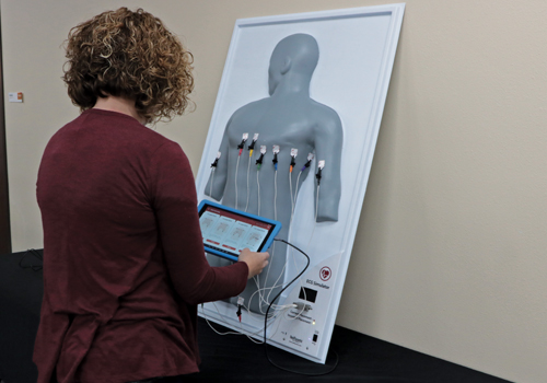 Student using Realityworks' ECG Simulator
