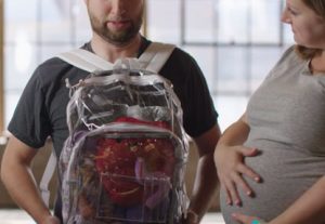 Student wearing backpack backwards