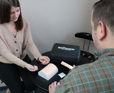EMT Student using Realityworks' Naloxone Training Kit