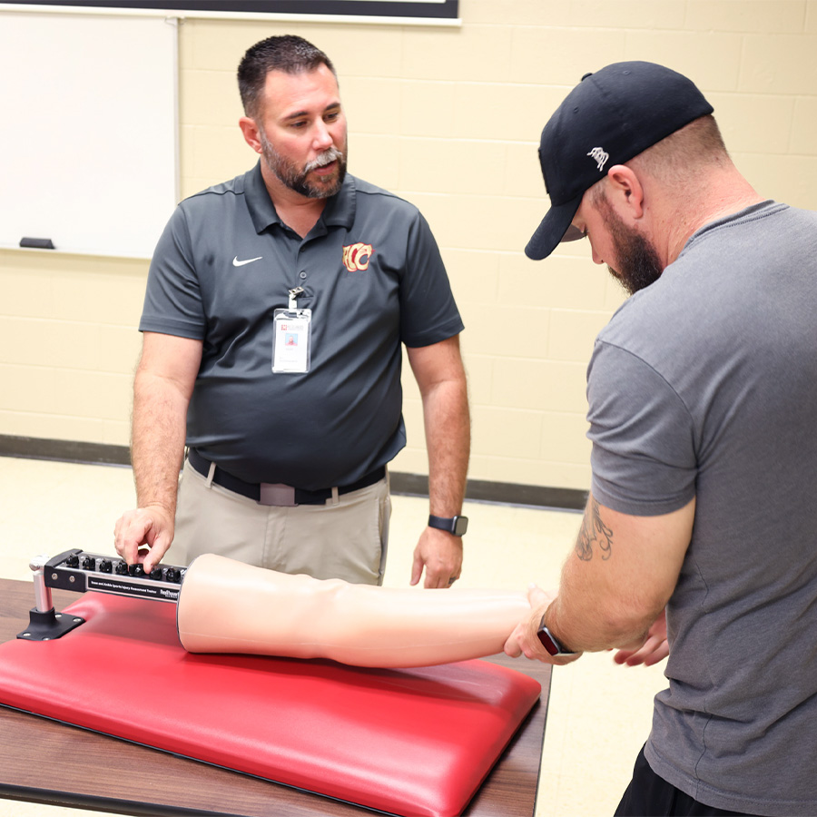 sports medicine program teacher and student use the Knee and Ankle Sports Injury Assessment Trainer