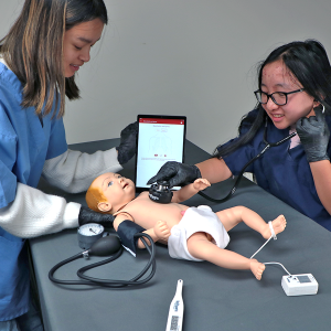 students practicing newborn physical assessments