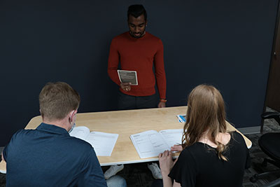 Students using workbooks and scenario cards
