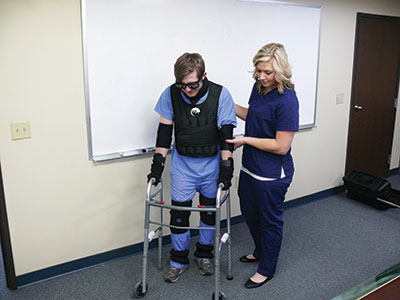 Student and teacher using geriatric simulator