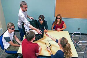 Teacher and students using the geriatric simulator
