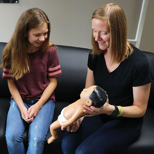 Teacher showing student Down Syndrome Baby