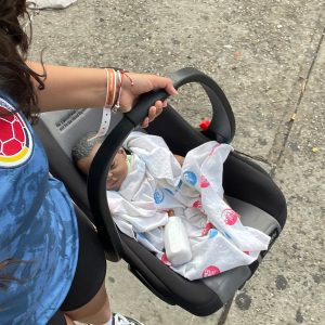 Student shows the RealCare Baby in the carrier