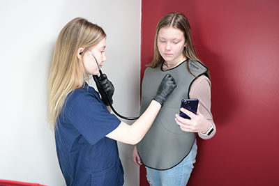 hands-on training tool - 2 students using the Wearable Auscultation vest