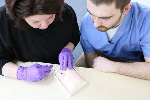 Students practicing on an injection pad