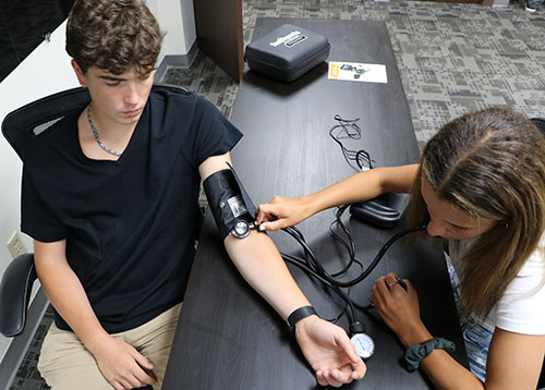 Students using blood pressure simulator