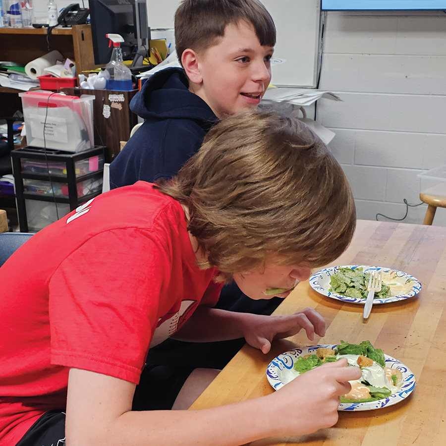 Students eat salads from the hydroponics system