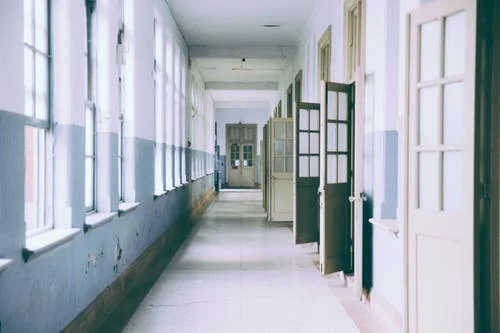 Naturally lit hallway with many open doors